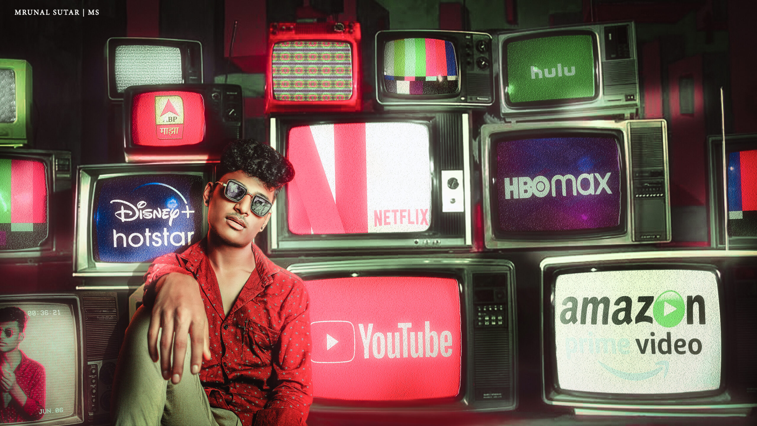 Creative portrait of a man in sunglasses sitting against a backdrop of vintage TVs featuring Netflix, YouTube, and streaming icons | LensVibrance creative photography