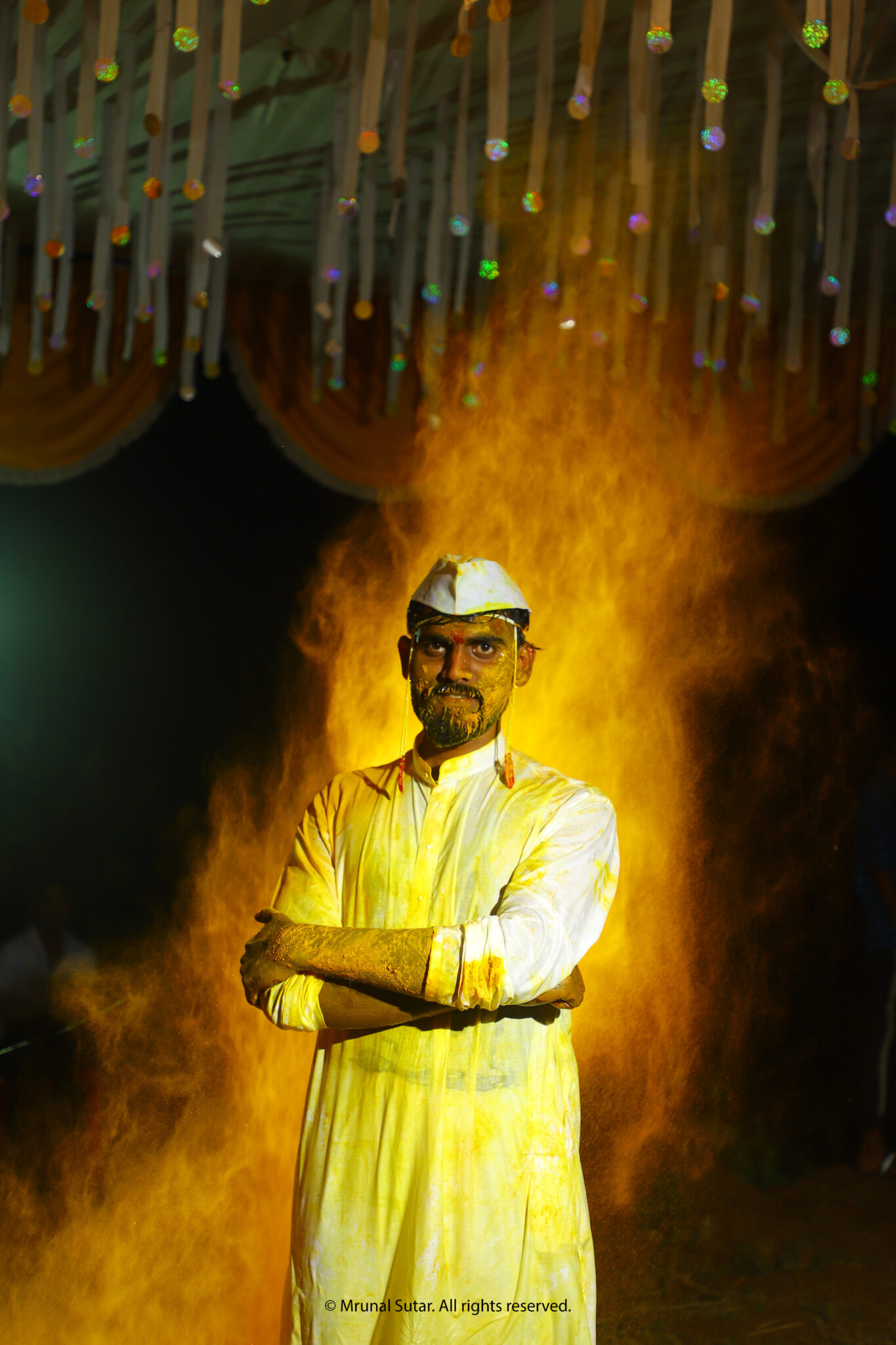 Haldi ceremony portrait with groom in yellow powder, cultural wedding photography by LensVibrance